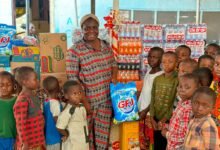 • One of the beneficiaries (second from right) receiving her item