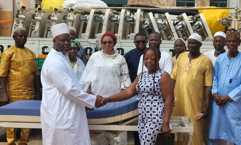 • Alhaji Kabore (left) presenting the items to Ms Awabre