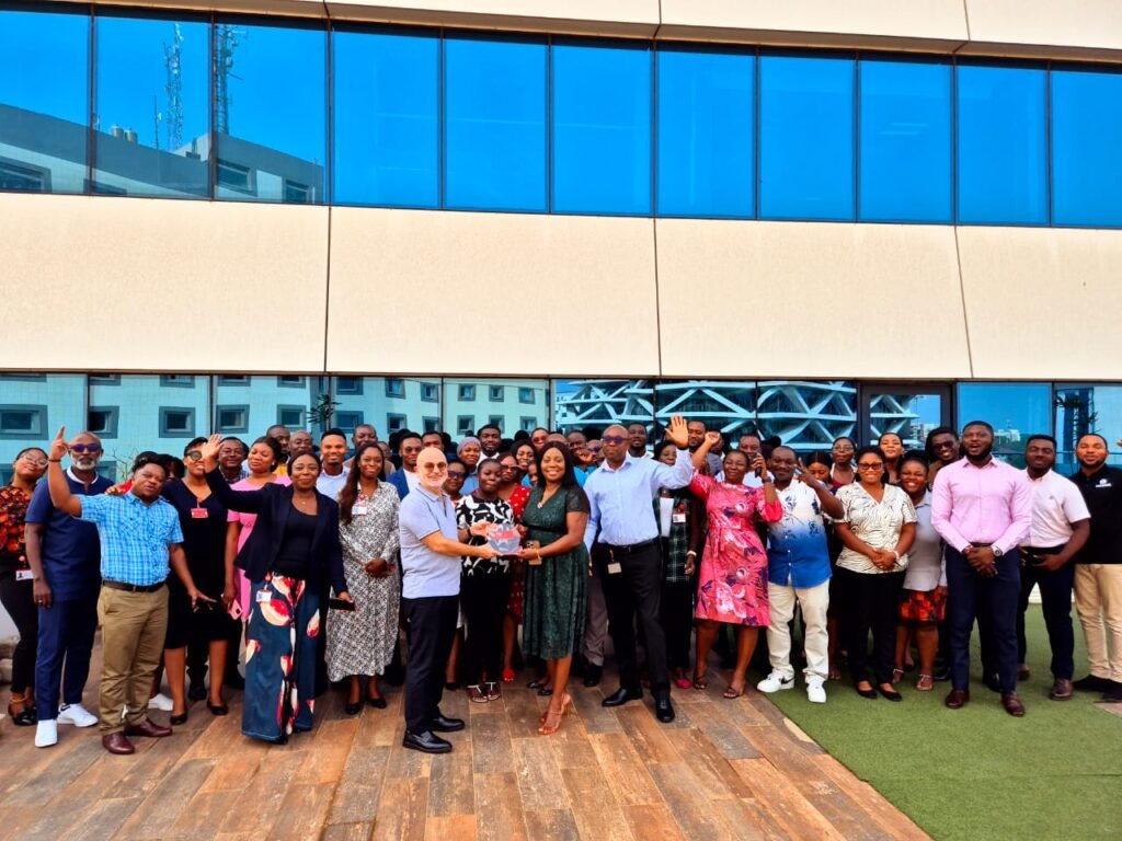 • Ing Obo-Nai and Mr Rifai jointly displaying the award. With them are some employees