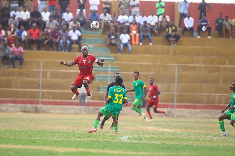 • Kotoko's Justice Blay in an aerial challenge as Nsoatreman players look on