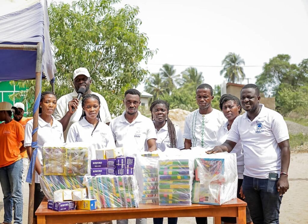 Dr. Francis Akwetey (with microphone) with Headteacher - Micheal Quarshie and staff of Ngmetsokope D/A School with the items donated