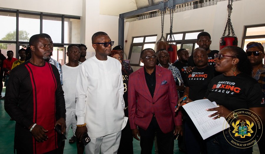 Madam Acquah-Harrison explaining a point to Mr Adams (second left) and other dignitries