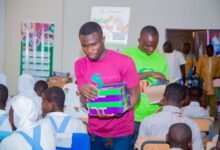 • Members of the foundation distributing educational materials to the beneficiaries