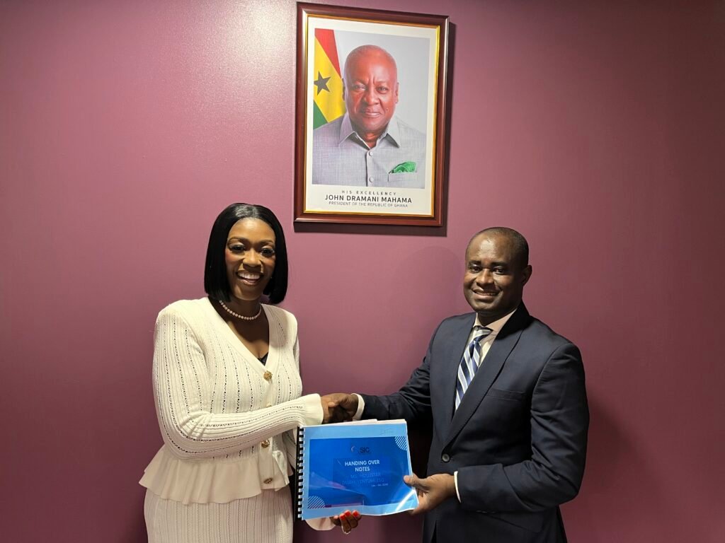 • Mr Agyenim-Boateng receiving the handover notes from Ms Duah-Yentumi