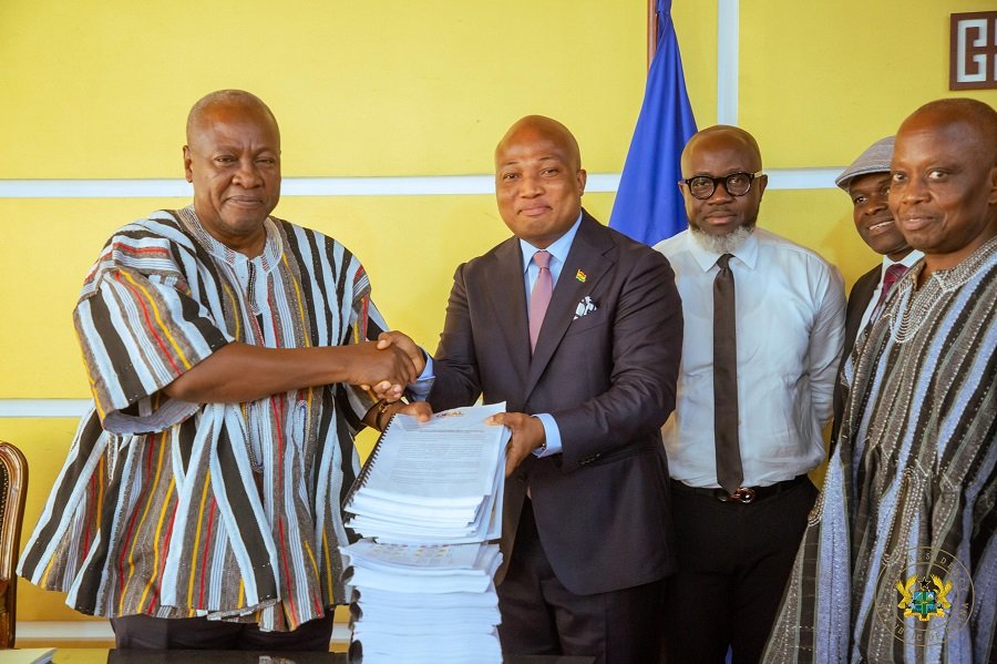 President Mahama (left) receiving the ORAL report from Mr Samuel Okudzeto Ablakwa (fourth from right). With them are ORAL team members