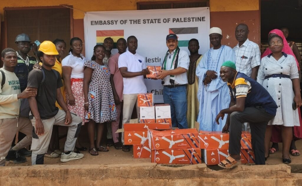 • Ambassador Abdalfatah Ahmed Khalil Alsatarri (middle) handing over the fans to the Mr Adams