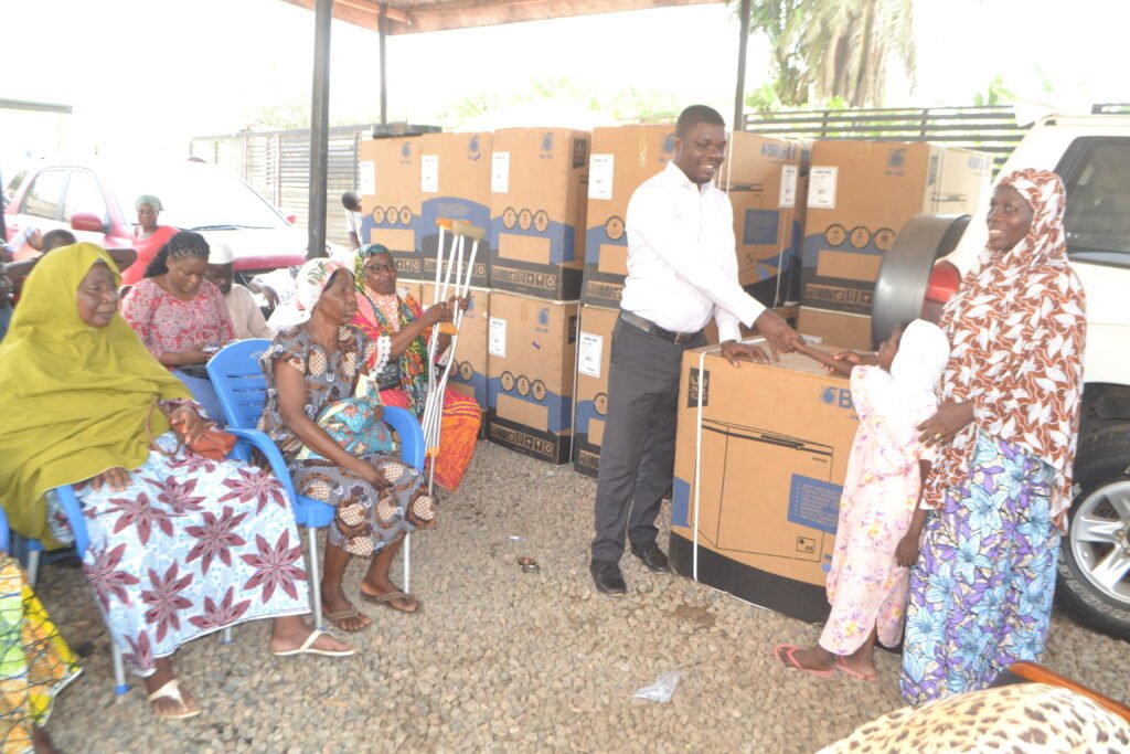 • Mr Boakye-Yiadom (third from right) presenting the roofing sheets