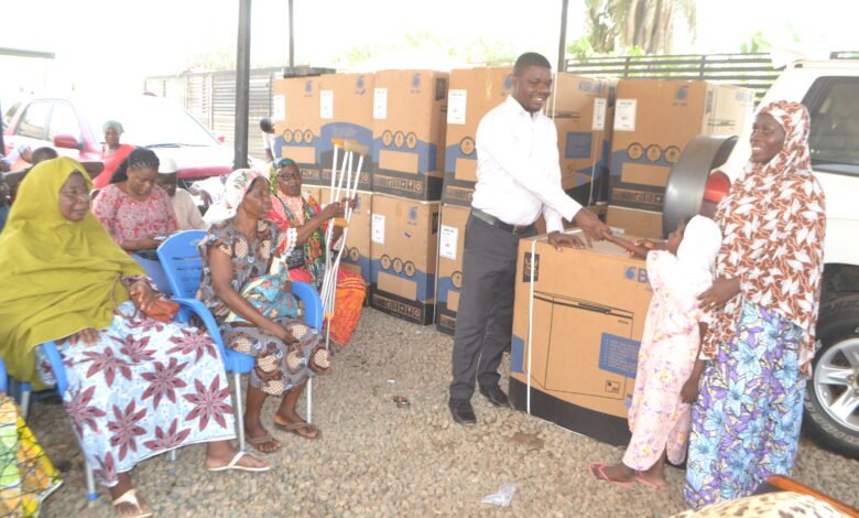• Mr Boakye-Yiadom (third from right) presenting the roofing sheets