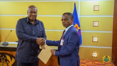 • President Mahama presenting his completed asset declaration forms to Mr Johnson Akuamoah Asiedu