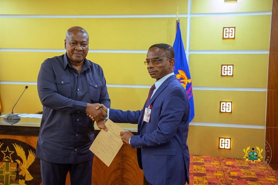 • President Mahama presenting his completed asset declaration forms to Mr Johnson Akuamoah Asiedu