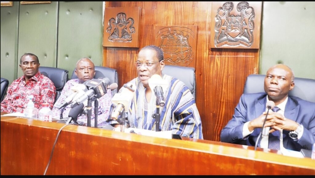 Mr Kapi (behind mic) addressing the press conference