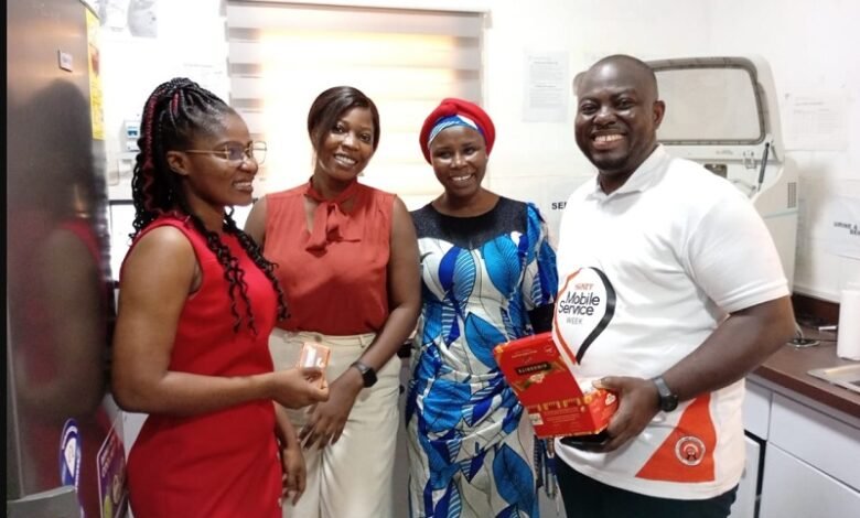• Mr Ofosu (right) and Ms Lamptey(left) presenting chocolate to some officials of the clinic
