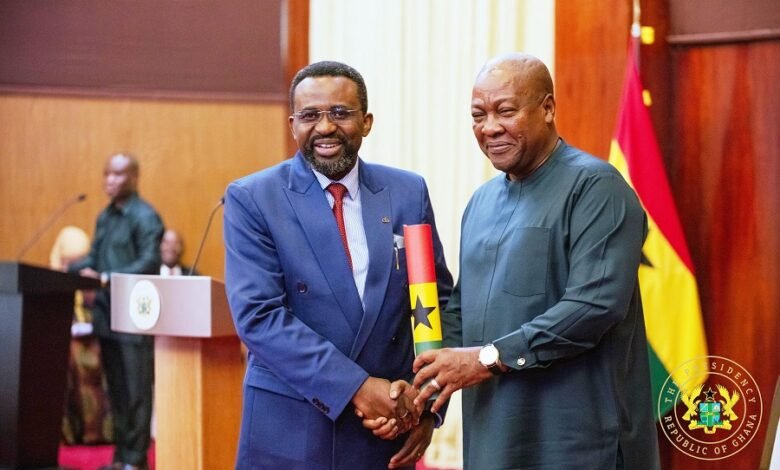 President Mahama presenting a scroll of office to Dr Asiamah