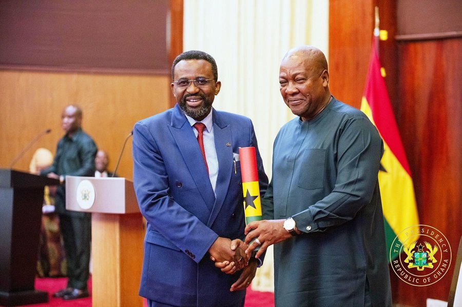 President Mahama presenting a scroll of office to Dr Asiamah