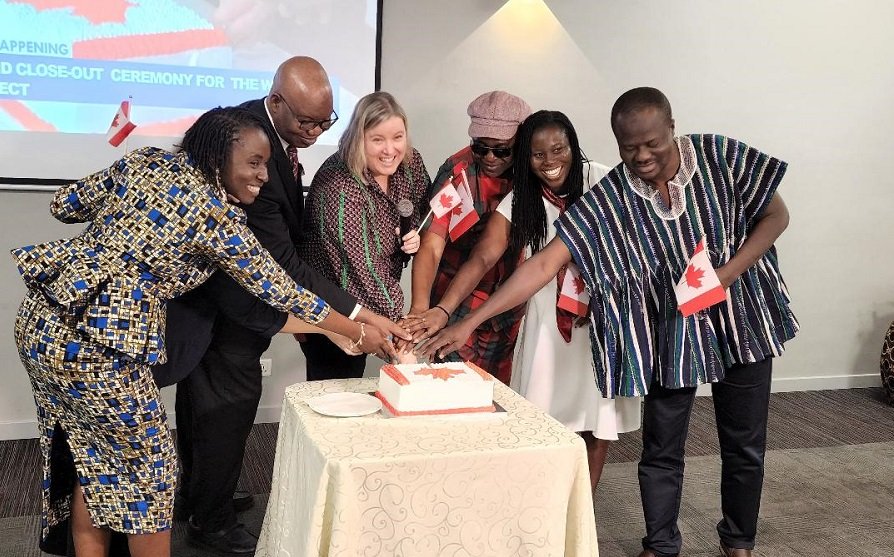 • Mr Tchona (second from left) with some officials of the Canadian Embassy and Plan International cutting a cake to signify the end of the project