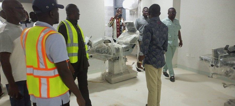 Mr Akandoh (rigt) inspecting the uninstalled theatre bed during his visit