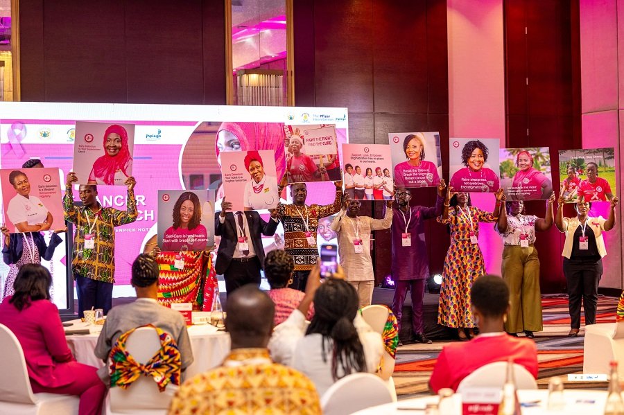 • Participants displaying images of breast cancer survivors at the ‘Beat Breast Cancer’ initiative