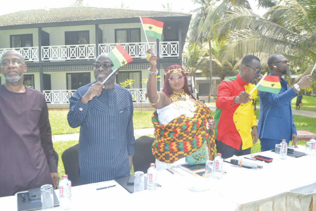 • Houadjeto (middle) and Mr Gilbert Abeiku Aggrey Santana (second from right) waving the flag of Ghana during the programme. With them are Mr Rex Omar (left) and Mr Kofi Okyere Darko (right) Photo: Victor A. Buxton