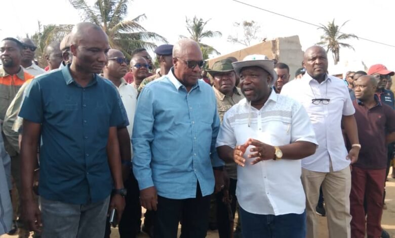 Mr James Gunu (right) explaining an issue to President Mahama (middle) at Amutinu community during the tour
