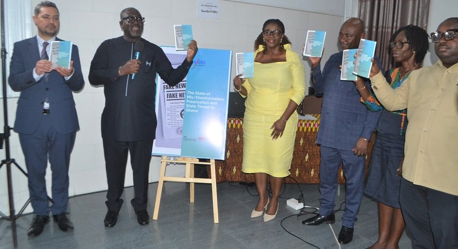 Mr George Sarpong (second from left) being assisted by Ms Addy and other dignitaries to launch the report Photo: Victor A. Buxton