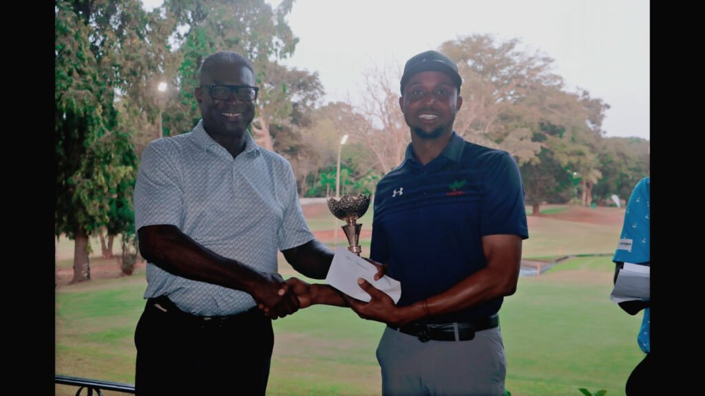 Vincent Torgah (right) receiving his trophy and cash prize from Mr Mike Aggrey