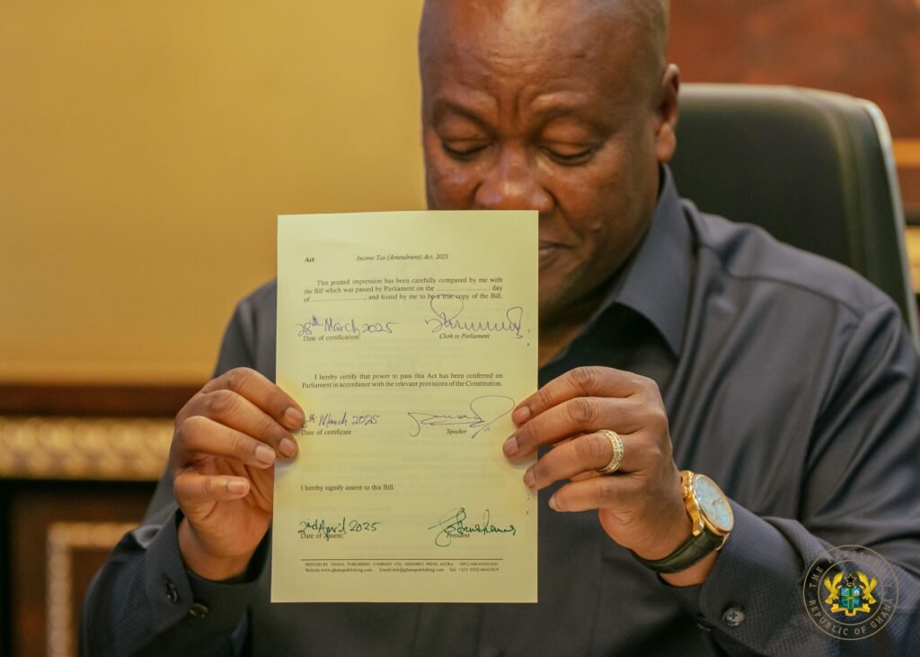 President John Mahama after assenting to the bill