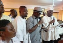 Mr Donatus Atanga Akamugri (in a hat), taking Mr Roland Atanga Ayoo (in smock), through the Oaths of Office and Secrecy