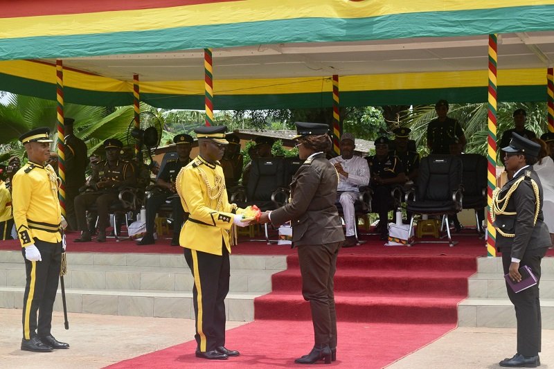 DGP Isaac Egyir (second from left) handing over the key of authority to DGP Patience Baffoe-Bonnie during the programme