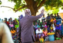 Dr Farouk Aliu Mahama waving back at the community members during his tour
