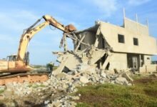 • A wheel loader machine breaking a building Photo: Seth Osabukle