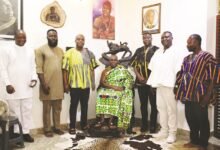 • Mr Clemence Gyato (standing second from right) with Omanhene Odeneho Kwafo Akoto III (seated) and other stakeholders