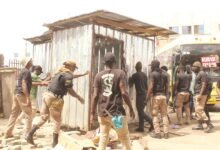 • Affected victims with their items (Inset): AMA taskforce pulling a container from unauthorised place at circle Photo: Ebo Gorman