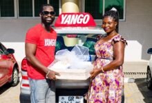 • An official of Yango presenting a gift to one of the beneficiary mothers