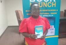 • Ms Evelyn Bekoe with the book at the launch