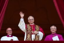 • Pope Leo XIV (middle) waving after the declaration
