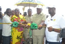 • Mr Joseph Nikpe (second from right) being assisted by Nana Oyi Bampoe Addo (second from left) and Mr Julius N. Kotey (right) to cut the tape for the inauguration of the office Photo: Victor A. Buxton