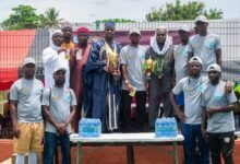 • Director of NAWGG, (standing third right on the raised platform) holding one of the trophies and other officials.