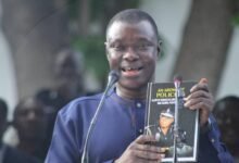 Professor Vincent Adzahlie-Mensah launching the book