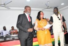 • Mrs Linda Ocloo (middle) swearing in Mr Christian Badger (left) after his confirmation Photo: Seth Osabukle
