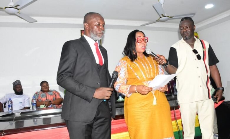• Mrs Linda Ocloo (middle) swearing in Mr Christian Badger (left) after his confirmation Photo: Seth Osabukle