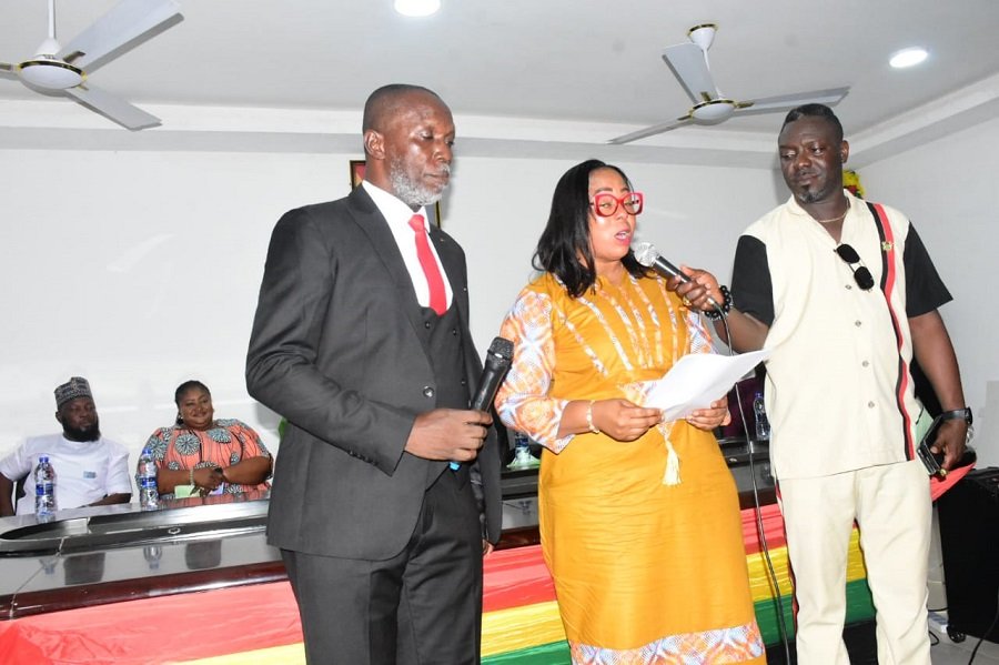 • Mrs Linda Ocloo (middle) swearing in Mr Christian Badger (left) after his confirmation Photo: Seth Osabukle