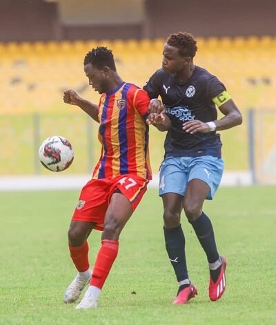 • Hearts Kwesi Asmah controling the ball away from his Accra Lions marker Issa Ibrahim (right)