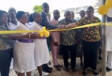 • Dr Ralph Armah (in suit) cutting the tape to inaugurate the Feto-Maternal Unit facility