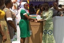 • Mrs Ackon (right) presenting the Upper West Region award to Ms Yahaya Salamatu from the Danyawkwra Community Based Health Planning Services (CHPS) compound