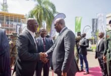 • President Mahama (right) exchanging greetings with Mr Moses Kwesi Baiden