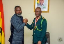 Mr Amadu (right) and Mr Asibey in a handshake, the armwrestling way