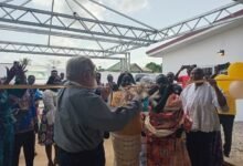 • Rev. Richards Ullman, (inset) cutting the ribbon to officially inaugurate the SOY Museum