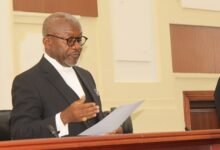 • Justice Noble Jerome Nkrumah (inset) swearing in the NMC board members Photo: Ebo Gorman