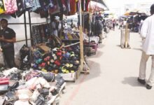 • Some traders doing business behind the red line at the Kwame Nkrumah Interchange in Accra Photo: Seth Osabukle