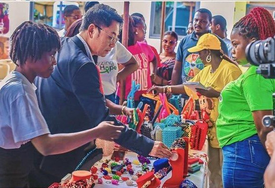 Mr Christian Li (second from left) inspecting some of the items on display at the programme